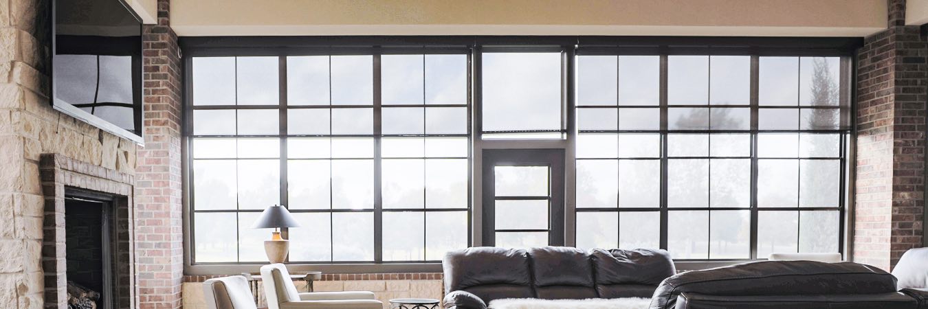 Motorized shades on tall windows in a living room