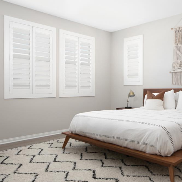 bedroom with white polywood shutters