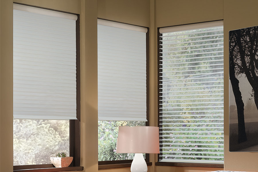 Gray sheer shades on windows in the corner of a modern living room