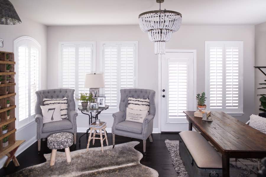 Polywood shutters on multiple windows in a sitting area