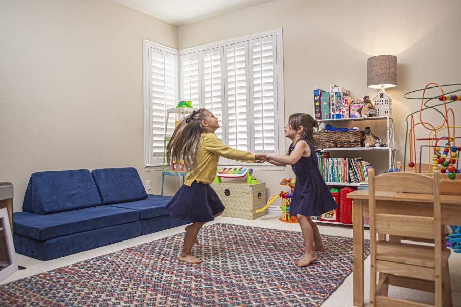 Choose Polywood shutters for durable, kid-friendly great room window treatments in Chicago. Polywood shutters on multiple windows in a sitting area