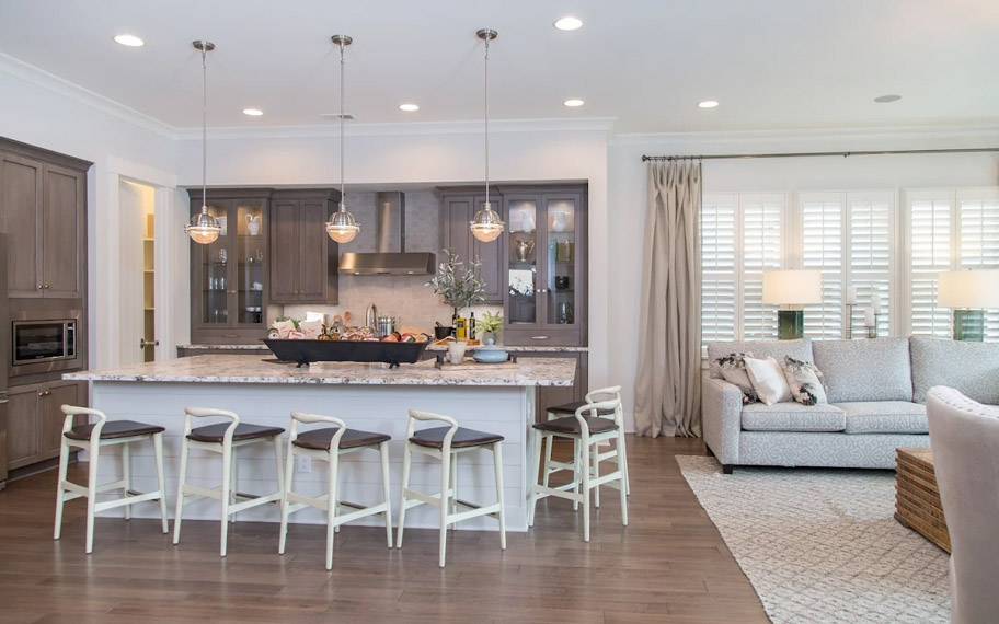 Illuminate your home with custom interior shutters in Chicago. White arched shutters in a white kitchen with lots of light.