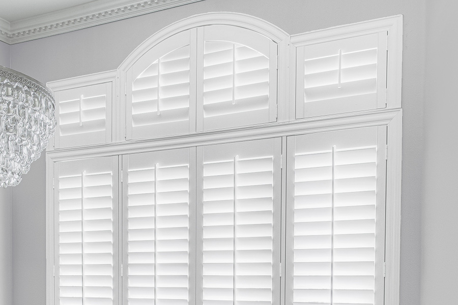 Customize your Palladian windows with white Polywood shutters in Chicago. White Polywood Palladian windows in a dining room.