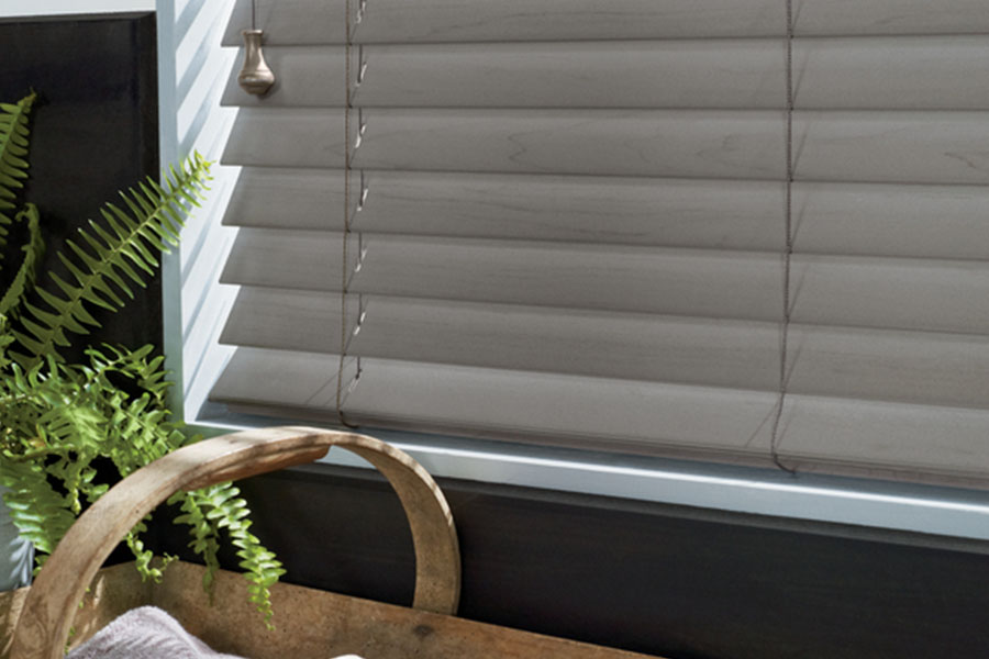  A close up view of gray blinds in a window
