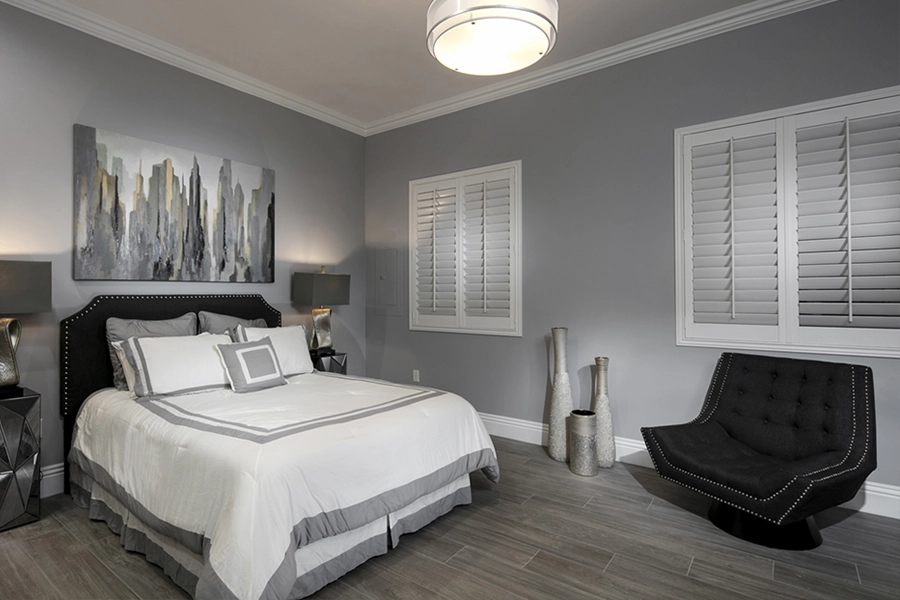 Close your custom Polywood shutters to beat the heat and keep your Chicago bedroom cool. White Polywood shutters on bedroom windows