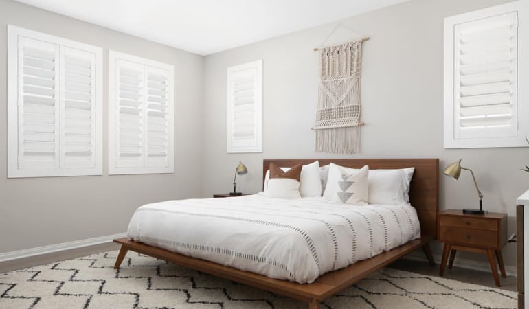 Open shutter louvers will help any Chicago room feel larger. Plantation shutters in a model home bedroom.