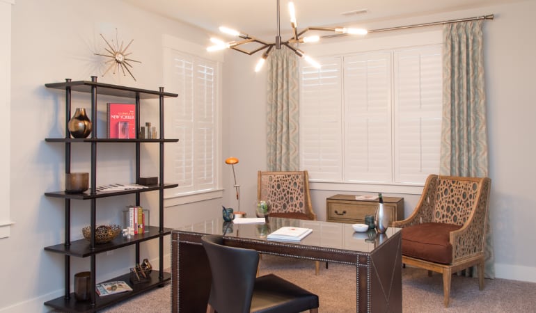 Picking the right window treatments can result in an increase in natural light. Chicago home office with plantation shutters.