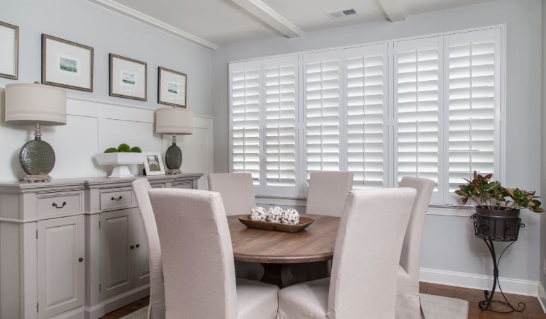 Plantation shutters are a perfect choice for homeowners looking for privacy or natural light. Plantation shutters in a Chicago dining room.