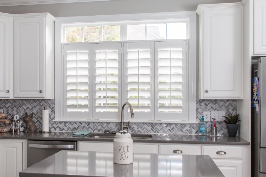 Classic Polywood interior shutters in Chicago are moisture-resistant. White Polywood shutters above a kitchen sink