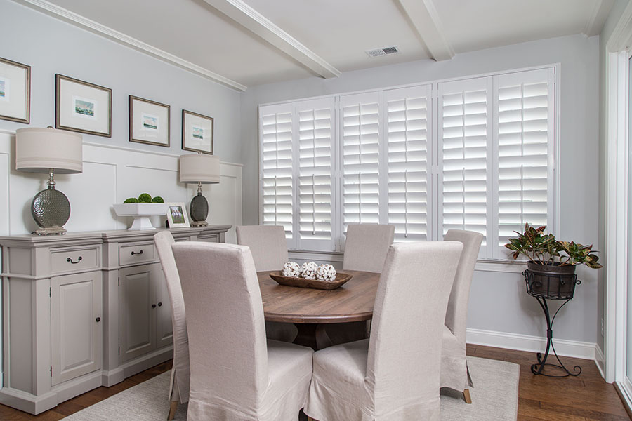 It only takes a quick swipe of your dust rag to keep Polywood shutters clean and beautiful. White Polywood shutters in a neutral colored dining room