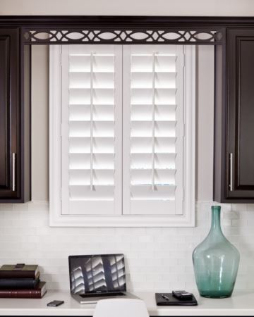 Shutters open by lifting a center tilt-rod -- no cords needed. Shutters in kitchen