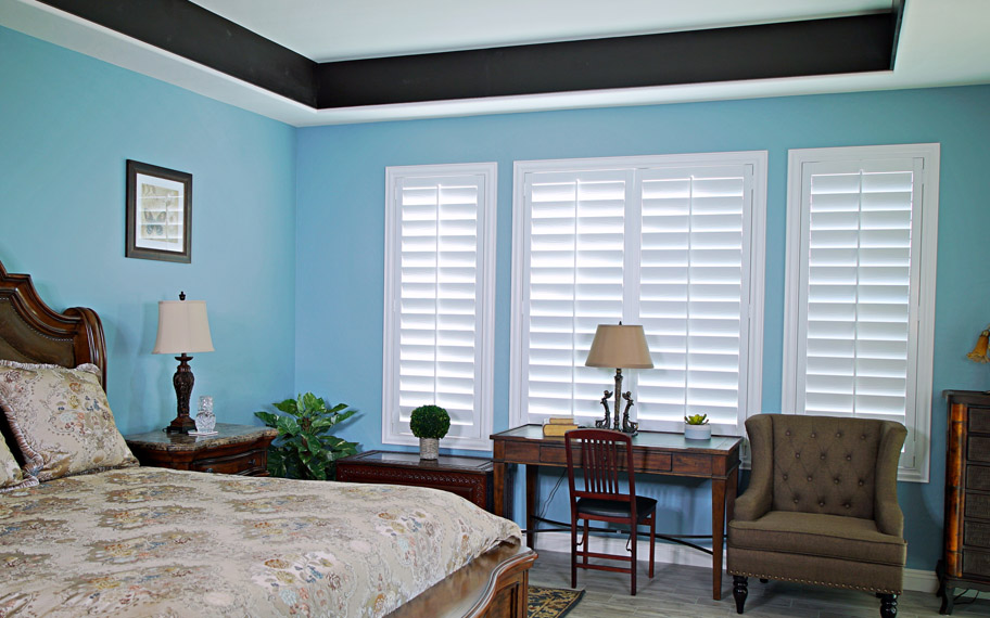 Polywood shutters provide insulation for the perfect temperature all year long in Chicago. Polywood shutters in a bedroom.