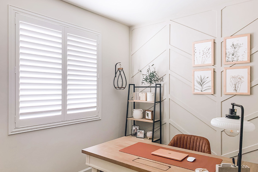 Polywood shutters give you maximum control over natural light in your Chicago home. Photo Credit: @OurLakepoint Farmhouse  White and off-white farmhouse style office with natural light from polywood shutters.
