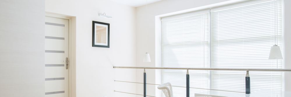 White loft room with white blinds.