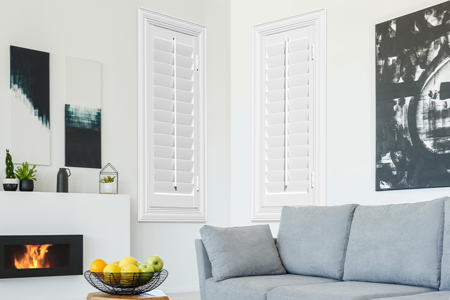 White Polywood shutters add character and class in Chicago. White polywood shutters in a corner of a modern living room.